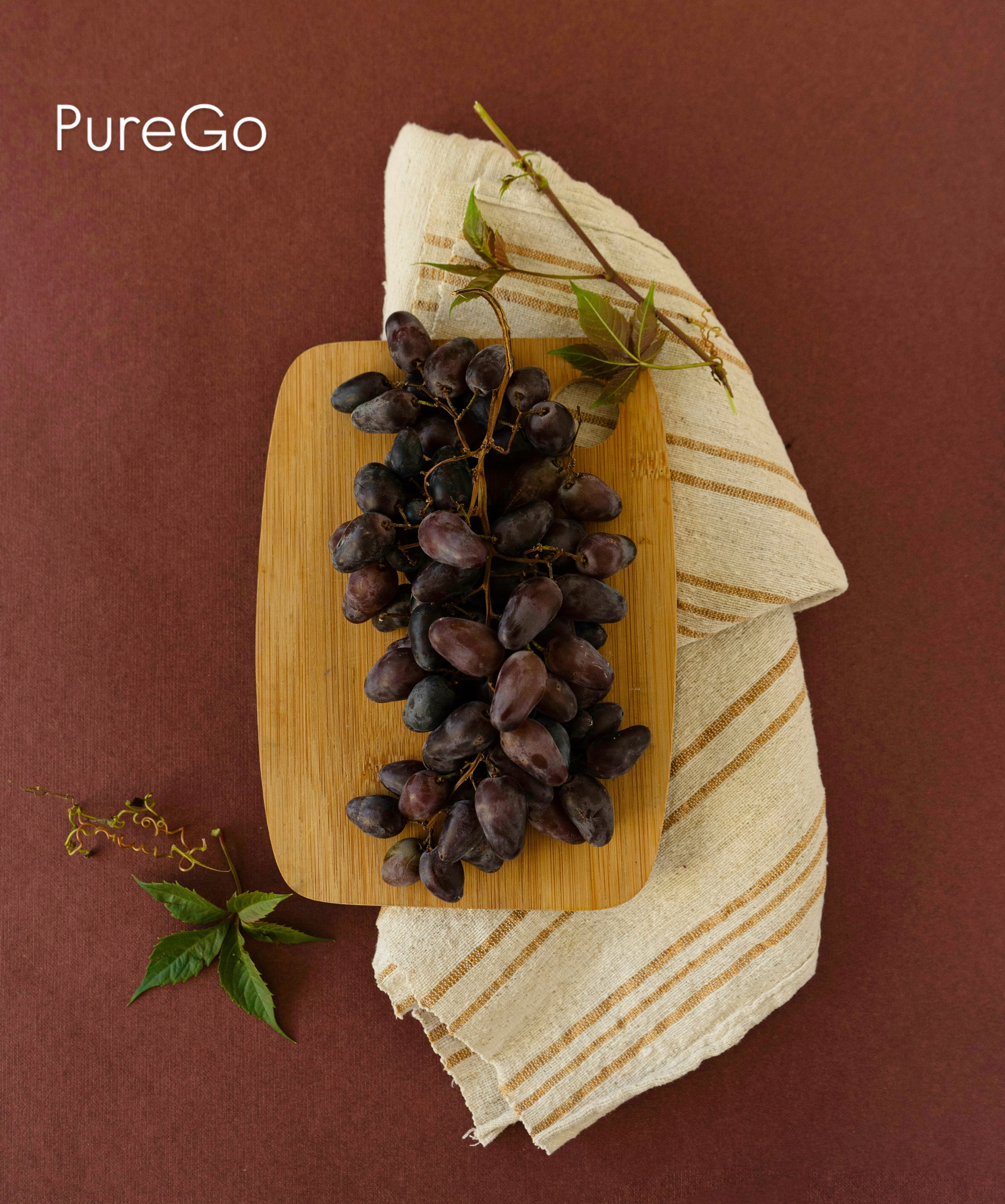 PureGo black grapes styled product shot on wooden board
